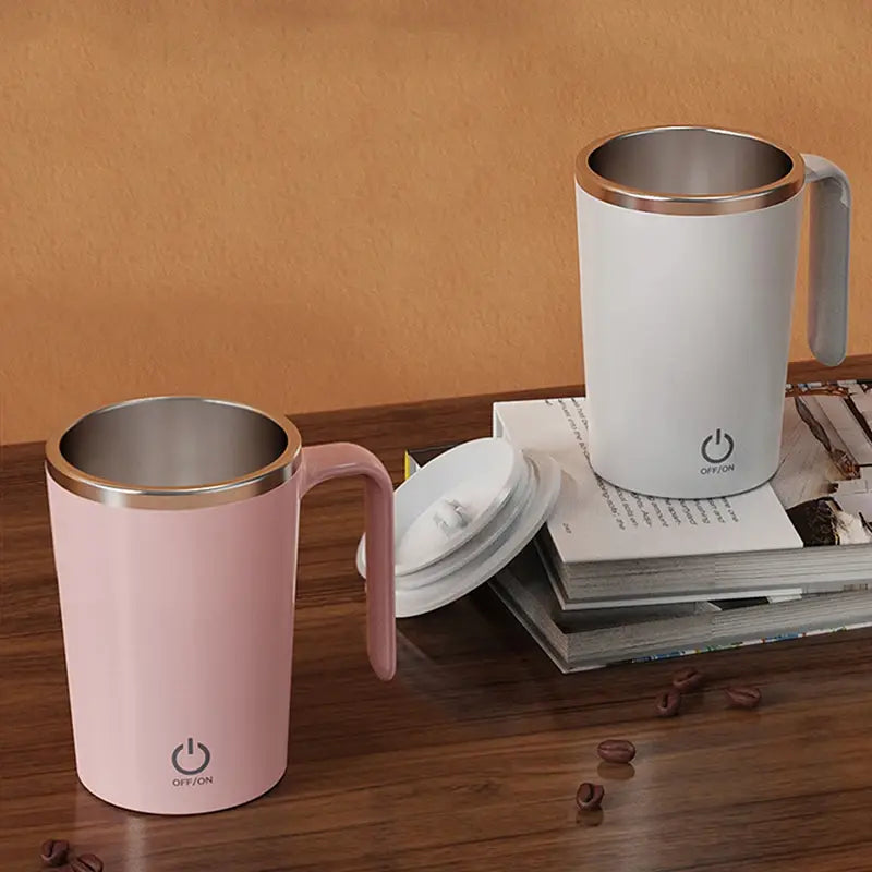 Automatic self-stirring magnetic mug in pink and white on a wooden table.