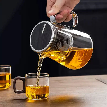 Magnetic switch tea maker pouring tea into a glass cup, highlighting sleek design and functionality.