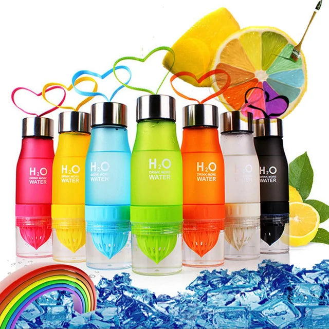 Colorful Fruit Infusion Water Bottles lined up with sliced citrus fruits in the background.