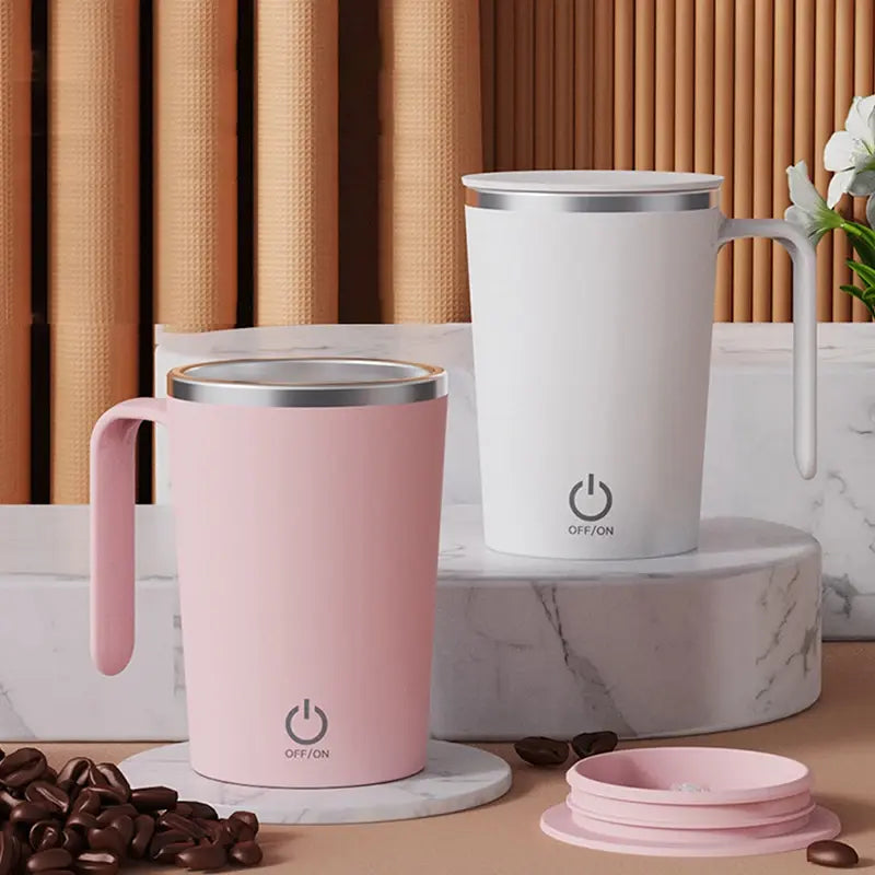 Automatic self-stirring magnetic mugs in pink and white on display.